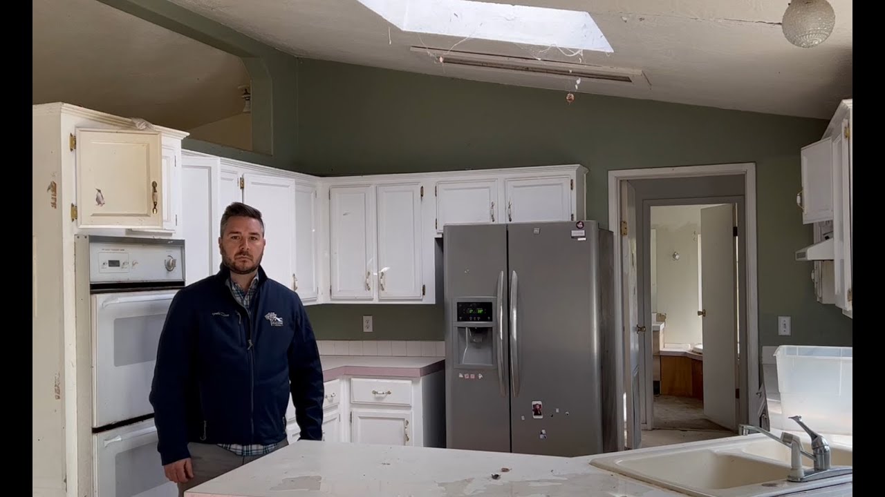 Jason Nesbitt of Peachtree Homes standing in the kitchen of a dated San Jose house